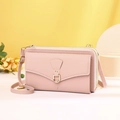 Detail view of pink crossbody phone bag showing three zippered layers and litchi texture - Pink