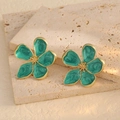 Close-up of golden flower earrings with green marble texture enamel and gold core details - Marble Green