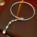 Macro detail of silver layered necklace featuring micro-set zircon and teardrop pendants - Silver