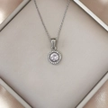 Close-up of a silver stainless steel necklace featuring a luxury round zircon pendant - Silver Peach Zirconia