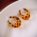 Macro shot of curved leopard print resin C-shaped hoop earrings on a ceramic dish - 13# Silver Needle - Brown - Oval