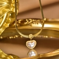 Macro detail of gold heart necklace with shell inlay and Love engraved pendant tag - Gold Snake Chain Heart Shell Pendant