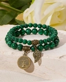 Detailed macro view of malachite beaded bracelets with bronze tree of life and leaf charms - Malachite