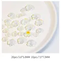 Macro detail of mixed size 3D pearl resin camellia nail art charms in white aurora finish - Camellia Mixed Transparent (S-03)