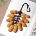 Artistic keychain with eleven lifelike peanut pendants on a black braided cord string - Peanut Perfection Cluster