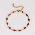Detail of a gold stainless steel bracelet with oval red glitter resin charms and clasp - 18+5cm / Red