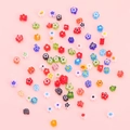 Colorful flower shaped glass beads for DIY jewelry making on pink background - Mixed
