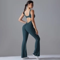 Detail of hollow back design and flared legs on dark teal athletic yoga jumpsuit - S / Deep Teal