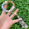 Close-up of beaded wristlet keychain with marble patterns, wooden bead, and snake skin tassel - Snake Printed Tassel Marble Beaded (款14)