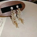 Detail of long pearl tassel earrings featuring floral resin petals and gold finish - Gold with White (Silver Needle)