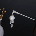 Detailed close-up of a silver floral hair stick with turquoise accents and hollowed leaves - Silver/F538/Floral Leaf Pendant