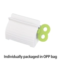 White and green manual toothpaste squeezer roller for facial cleanser and creams - OPP Bag / Green