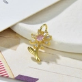 Macro detail of sunflower pendant with pink and white zircon in gold plating - Pink