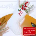 White cable knit Christmas stocking with red embroidered letter E and holly leaf - Letter E / White
