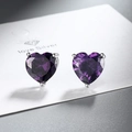 Macro shot of purple heart zircon earrings with silver three-prong setting and facets - Purple Zirconia