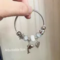 Silver bead bracelet with dolphin and heart charms featuring adjustable steel cable band - Dolphin Lover Bracelet