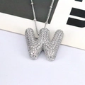 Macro view of silver 3D letter W pendant with pavé cubic zirconia on bead chain - Letter W