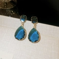 Elegant close-up view of blue teardrop crystal earrings with gold plated settings - 11# Silver Pin - Blue
