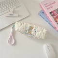 Detail of quilted pencil case with sunbeam bear embroidery in a desk setup - Cloud Animal
