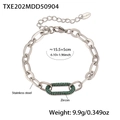 Macro detail of horseshoe clasp bracelet in stainless steel with green zircon stone - Steel Color Green Zirconia Bracelet (TXE202)