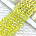 Macro shot of 8mm faceted lemon yellow glass beads with iridescent AB coating for jewelry DIY - Lemon Yellow AB
