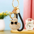 Detailed view of rhinestone duck keychain with gold lobster clasp and braided leather strap - Braided Black Rope + White Rhinestone Duck