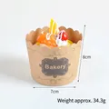 Artificial cream cupcake in brown bakery paper cup with scalloped edges and fruit topping - Walnut
