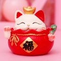 Lucky cat resin figurine with gold ingot and fú bag in traditional red and white colors - Fortune Bag Shaking Head