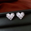 Close-up of heart-shaped silver earrings with paved cubic zirconia on black leather display - Silver
