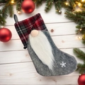 Christmas stocking with grey felt, red plaid gnome and snowflake on white wood background - Faceless Gnome Grey Christmas Stocking