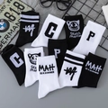 Classic black and white crew socks featuring street style letters and cartoon face - Multi Style Collection
