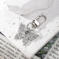Detailed view of silver crystal butterfly keychain with rhinestones on a textured background - Silver Butterfly