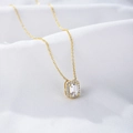 Macro shot of gold square zircon necklace with emerald-cut stone on white silk - 925 Silver / Yellow