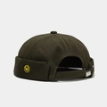 Close-up of olive green cotton docker hat featuring yellow smiley face embroidery and metal buckle - Solid Smile Army Green