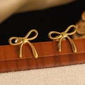 Elegant gold bow-shaped stud earrings featuring a polished metallic finish - Gold Bowknot Curved Design Stud Earrings