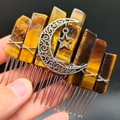 Macro shot of tiger eye crystal hair comb with silver moon and star metal pendants - Tiger's Eye