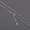 Close-up of silver beaded cross chain with lobster clasp and crystal pendant - Silver Fine Bead Chain