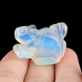 Miniature frog sculpture carved from translucent milky crystal with blue opal flash - Opal (Synthetic)