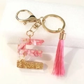 Pink resin letter E keychain with gold foil flakes and matching soft tassel pendant - Letter E