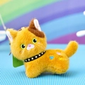Macro detail of a cute ginger plush cat keychain with a black spiked collar and embroidery - Lying Style / 12cm / Brown