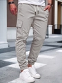 Detail of light grey cargo pants featuring drawstring waist and large side pockets in street setting - Light Gray