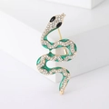 Detail of snake brooch with gold plating, green enamel, and sparkling crystals - Green Spirit Snake