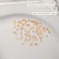 Mix of 100 mini flatback nail crystals in light yellow assorted shapes on a pearl tray - Approx. 100 Pcs / Transparent Champagne