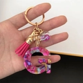 Detail of resin letter G keychain with pink tassel, colorful stones, and star glitter ball - Small Ball Tassel Clasp / Letter G