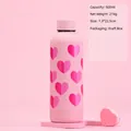 Close-up of a 500ml pink insulated tumbler with heart patterns and dimensions on a pink stand - 500ml Dot Cup