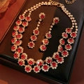 Exquisite close-up of double-layer gold necklace and red floral earrings in a display box - Gold-Red