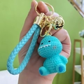 Cute light blue cartoon dinosaur resin keychain with braided strap and golden bell charm - Blue Dinosaur