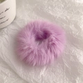 Close-up of soft purple faux fur hair tie scrunchie on textured white background - Light Purple