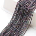 Close-up of 2mm faceted glass beads with rainbow metallic luster for DIY jewelry making - Multicolor