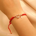 Macro shot of red braided Virgin Mary heart bracelet with gold cross and zircon inlay - KC Gold Red Rope (G-310)